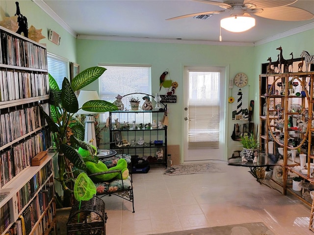 misc room featuring light tile patterned floors, ceiling fan, and crown molding