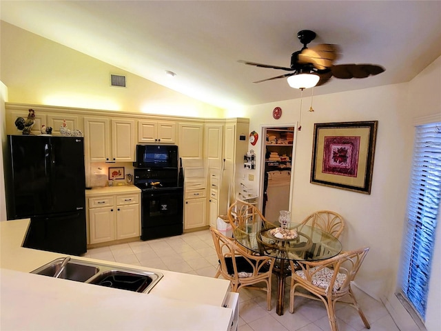 kitchen featuring ceiling fan, sink, vaulted ceiling, light tile patterned flooring, and black appliances