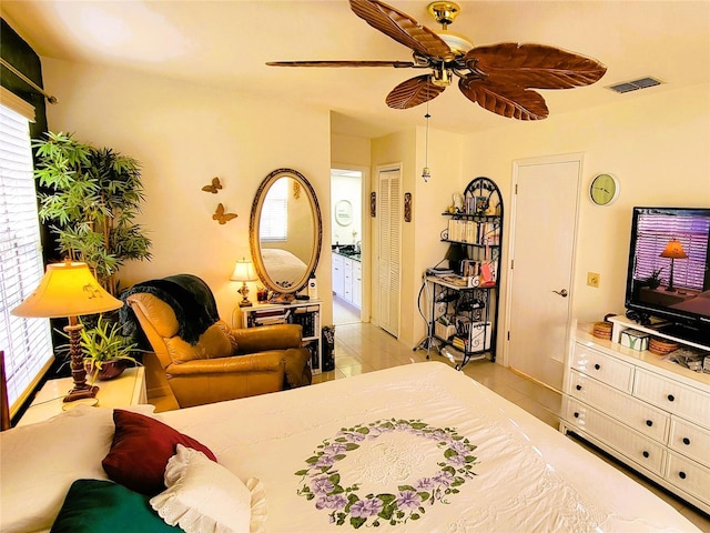 bedroom featuring ceiling fan and ensuite bath