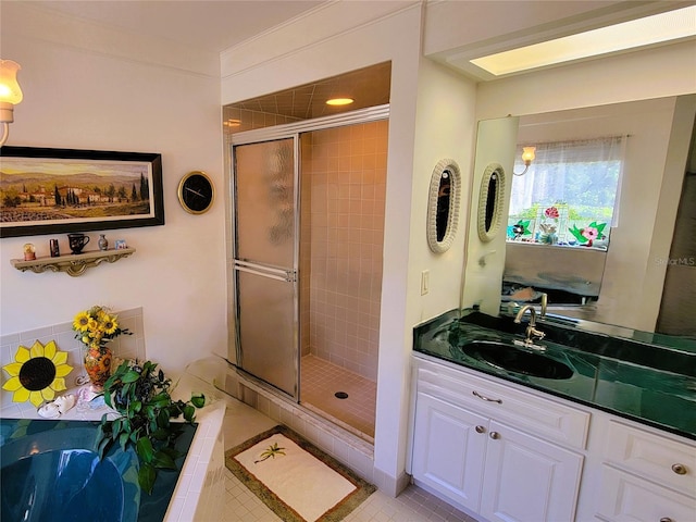 bathroom featuring a shower with door, vanity, and tile patterned flooring