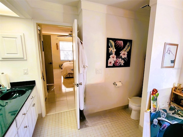 bathroom featuring tile patterned flooring, vanity, and toilet