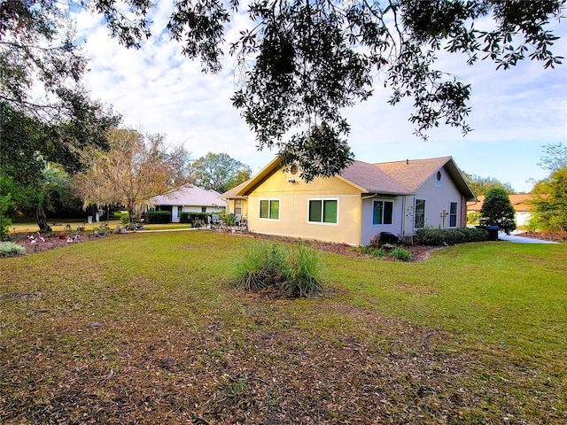 view of side of home with a lawn