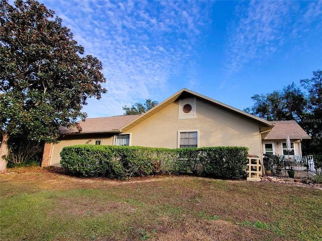 view of home's exterior featuring a lawn