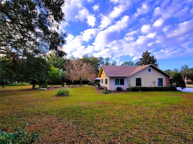 view of side of property featuring a yard