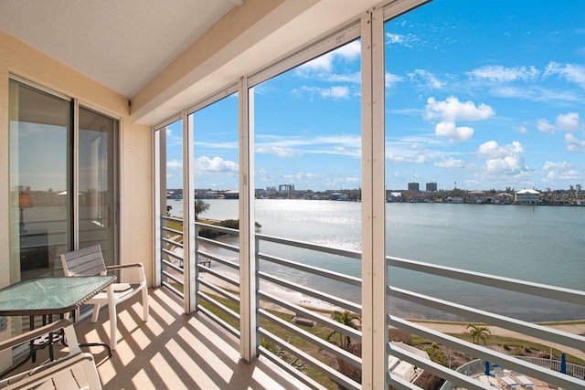 sunroom featuring a water view