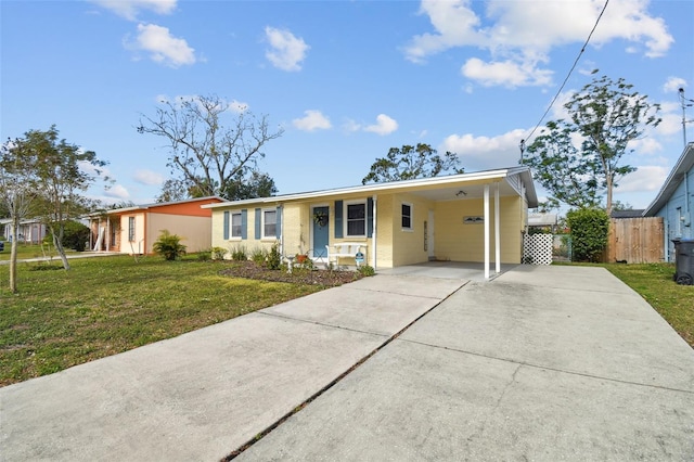 view of front facade with a front yard and a carport