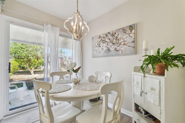 dining room with a chandelier and wood-type flooring