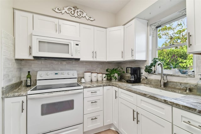 kitchen featuring white appliances, white cabinets, sink, tasteful backsplash, and stone countertops