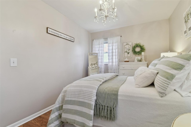 bedroom featuring wood-type flooring and a chandelier