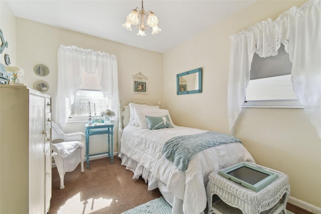 bedroom featuring a notable chandelier and carpet floors