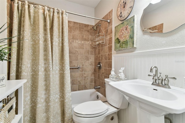 full bathroom with toilet, shower / bath combo with shower curtain, and sink