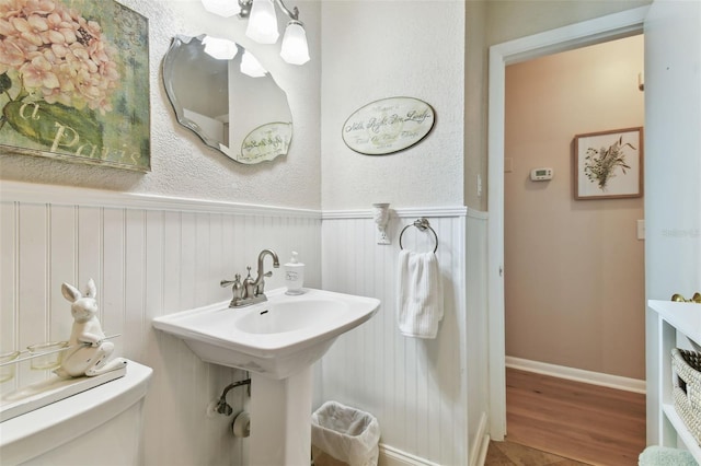 bathroom featuring toilet and wood-type flooring