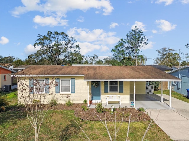 ranch-style house with a carport, a porch, and central AC