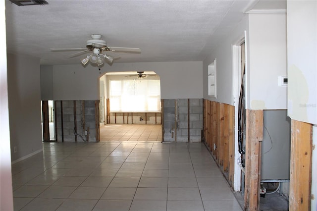 tiled empty room with ceiling fan