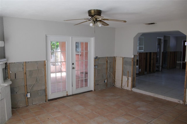 entryway featuring ceiling fan, light tile patterned floors, and french doors