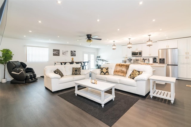 living room with french doors, ceiling fan, and dark wood-type flooring