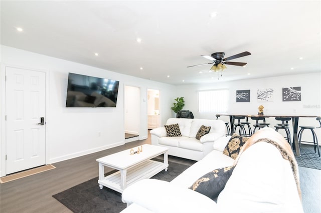 living room with ceiling fan and dark hardwood / wood-style floors