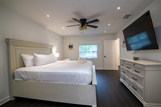 bedroom with dark hardwood / wood-style flooring and ceiling fan