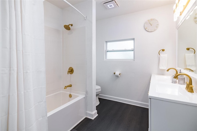 full bathroom with hardwood / wood-style floors, vanity, shower / bath combination with curtain, and toilet