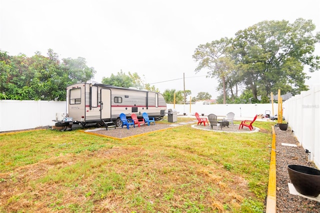 view of yard with an outdoor fire pit