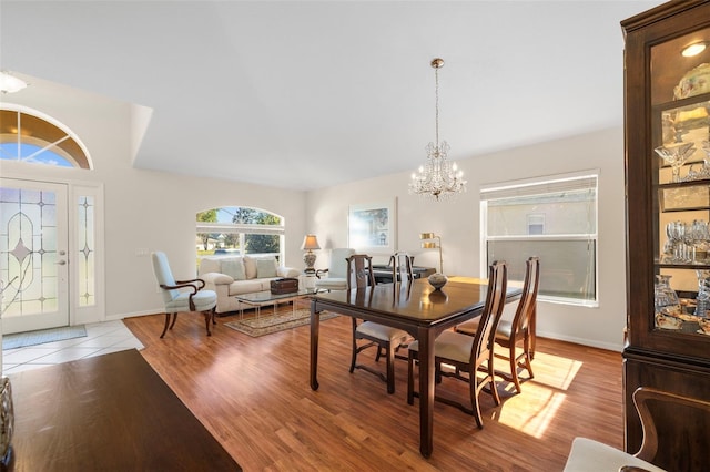 dining space featuring light wood-type flooring and a chandelier