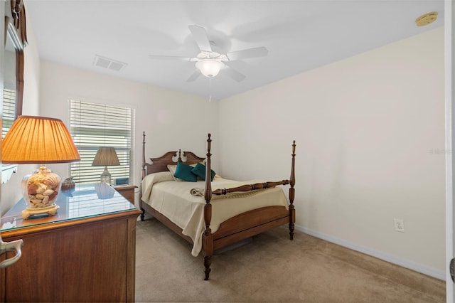 bedroom with ceiling fan and light carpet