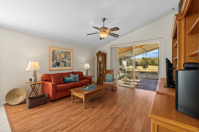 living room featuring ceiling fan, vaulted ceiling, and wood-type flooring