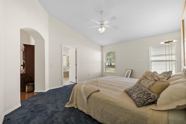 carpeted bedroom featuring ceiling fan, connected bathroom, and lofted ceiling