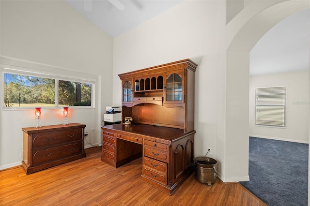 office with high vaulted ceiling, ceiling fan, and light hardwood / wood-style floors