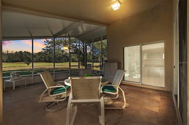 sunroom / solarium featuring lofted ceiling