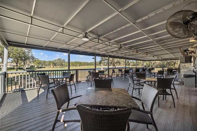 deck featuring ceiling fan and a water view