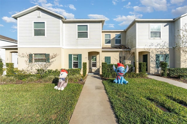 view of property featuring a front lawn