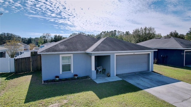 ranch-style house featuring a front yard and a garage