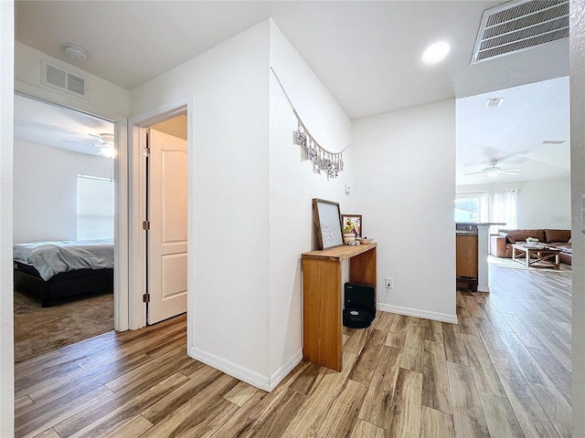 hallway with light hardwood / wood-style flooring