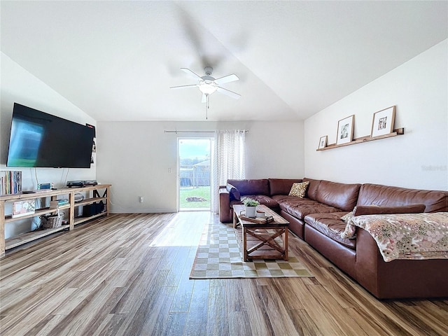 living room featuring ceiling fan, hardwood / wood-style floors, and lofted ceiling