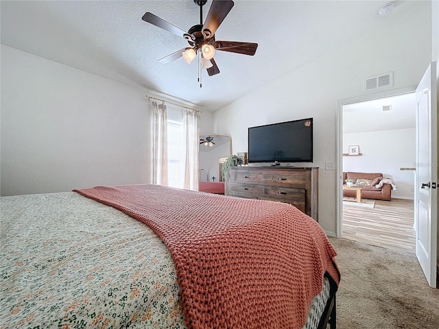 carpeted bedroom featuring vaulted ceiling and ceiling fan