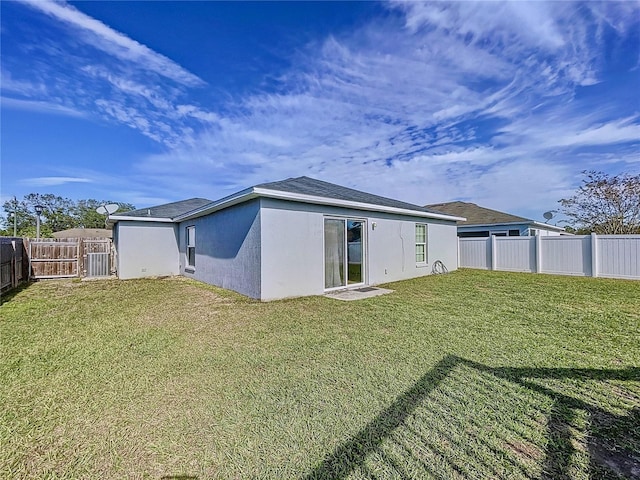 rear view of property with a yard