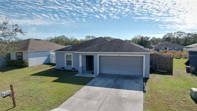 single story home featuring a garage and a front lawn