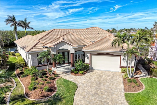 mediterranean / spanish home with a garage