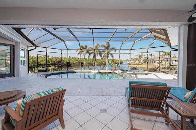 view of patio featuring a lanai, ceiling fan, a water view, and a pool with hot tub