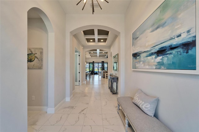 corridor with marble finish floor and baseboards