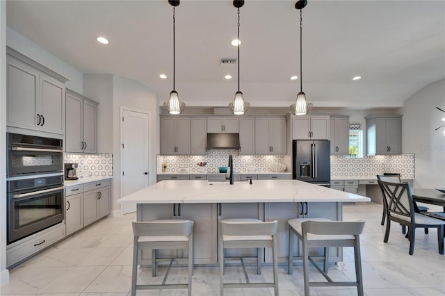 kitchen featuring double wall oven, high quality fridge, a sink, and gray cabinetry