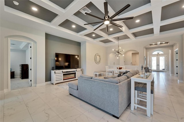 living area with arched walkways, marble finish floor, coffered ceiling, and visible vents