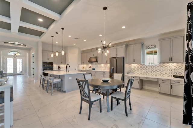 dining space featuring marble finish floor, french doors, coffered ceiling, and recessed lighting