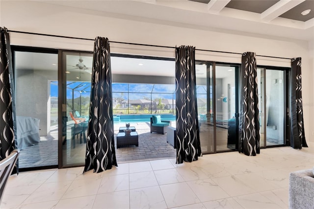 interior space with a sunroom, marble finish floor, and beamed ceiling