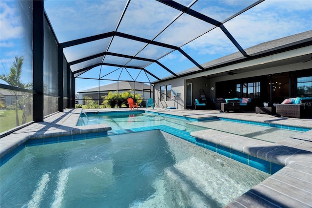 outdoor pool featuring a patio area, glass enclosure, an outdoor hangout area, and a ceiling fan