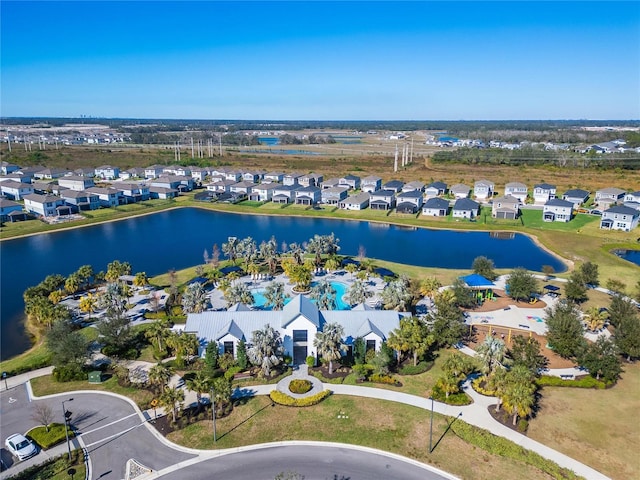 birds eye view of property with a water view and a residential view