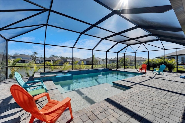 view of pool featuring a lanai, a pool with connected hot tub, a residential view, and a patio