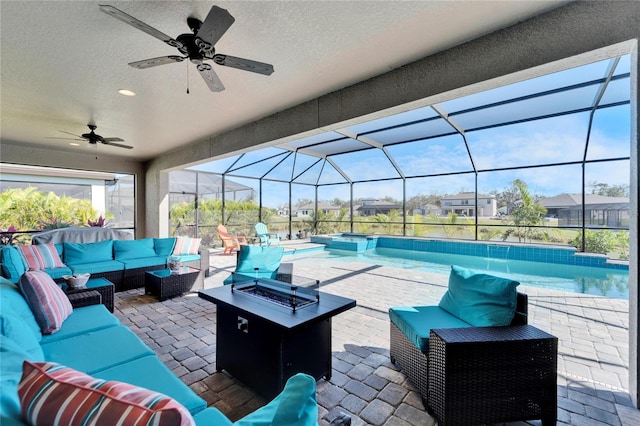 view of patio / terrace with glass enclosure, an outdoor living space with a fire pit, and a pool with connected hot tub