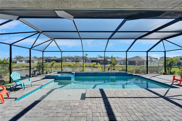 view of pool with a residential view, a pool with connected hot tub, a patio, and a lanai